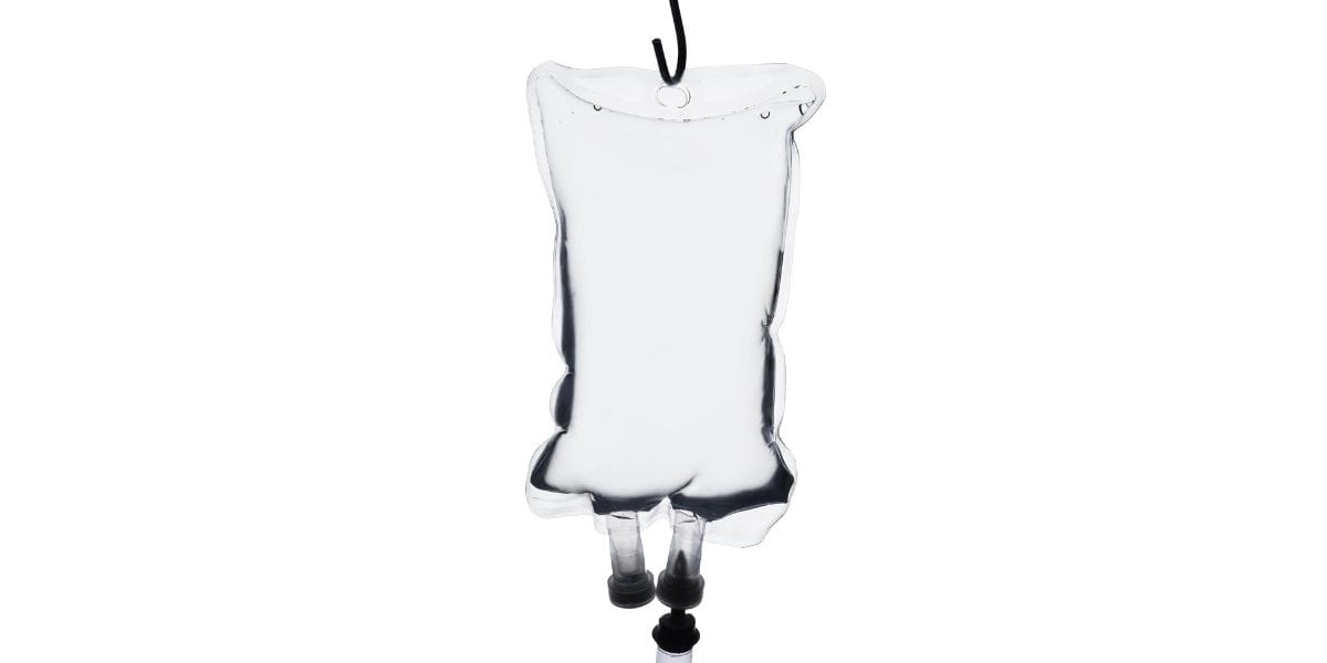 A glass tube suspended from a wall hook, showcasing its transparent structure and smooth surface.