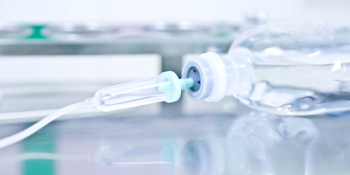 A bottle with a needle attached, typically used for administering medication or vaccines.