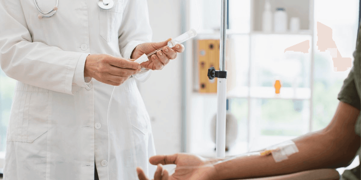A doctor prepares to draw blood from a patient during a medical examination in a clinical setting.